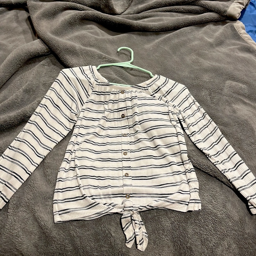 Long sleeve tee with buttons down the middle and a tie at the bottom